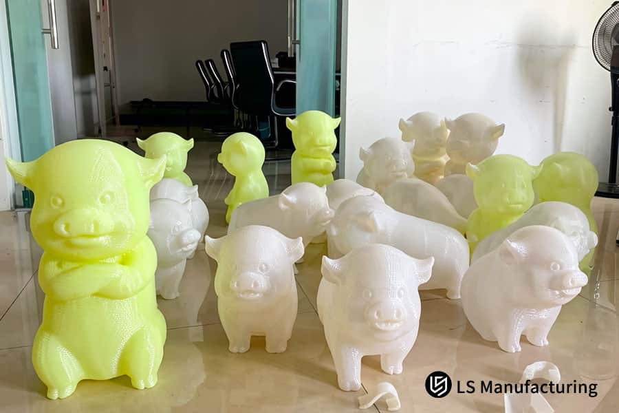 A collection of yellow and white animal figurines showcases mass production capabilities.