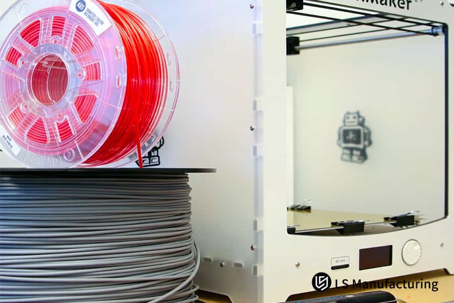 3D printing manufactures red and gray polycarbonate parts for robotic assembly lines.