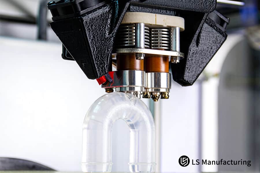 3D printing constructs a transparent elbow pipe using durable polycarbonate material.