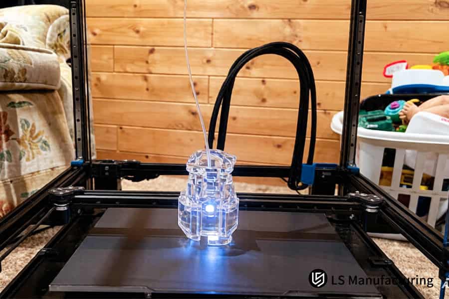 3D printing creates transparent polycarbonate pipes for fluid transfer systems in a home workshop.