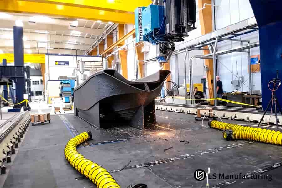 Robotic arm performs precision trimming on large scale 3D printed vessel component.