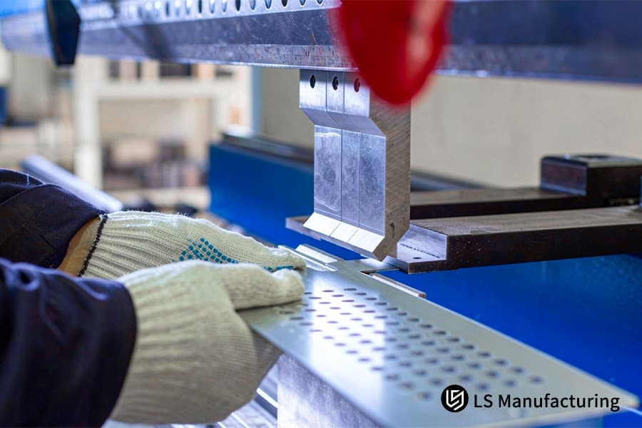 Bending a perforated carbon steel strip for industrial ventilation grilles or filter panel frames.