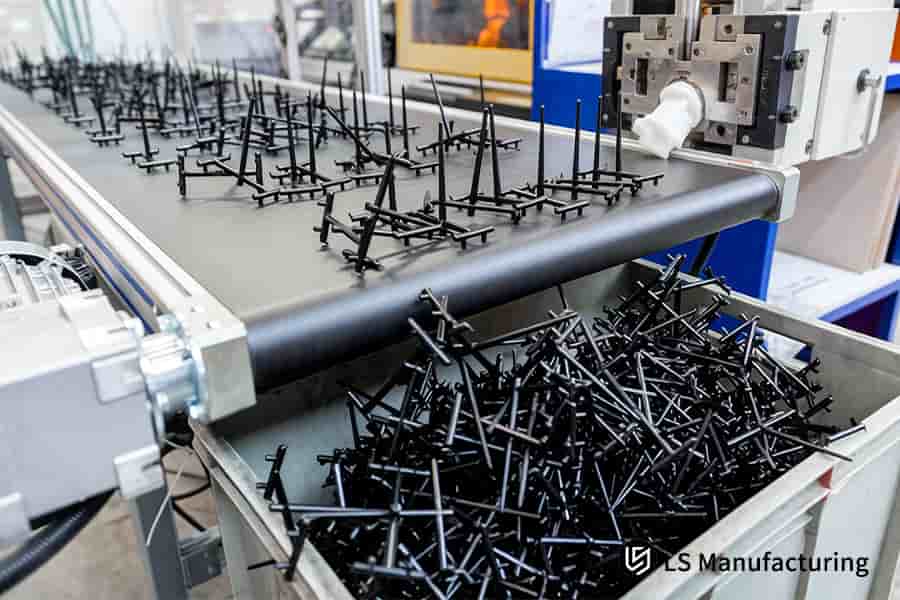 Conveyor transports black plastic hangers through final packaging stages using automated sorting mechanisms.