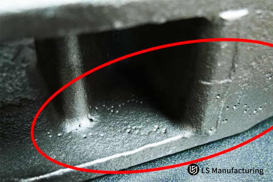 Metal casting showing surface porosity defects