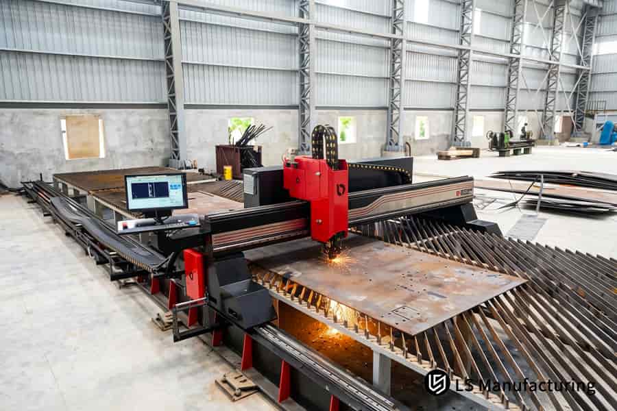 The CNC laser cutting system slices large format mild steel coils with automation for construction machinery.