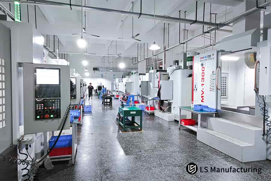Operator monitors multiple cnc machines performing high precision aluminum cutting operations for industrial component manufacturing.