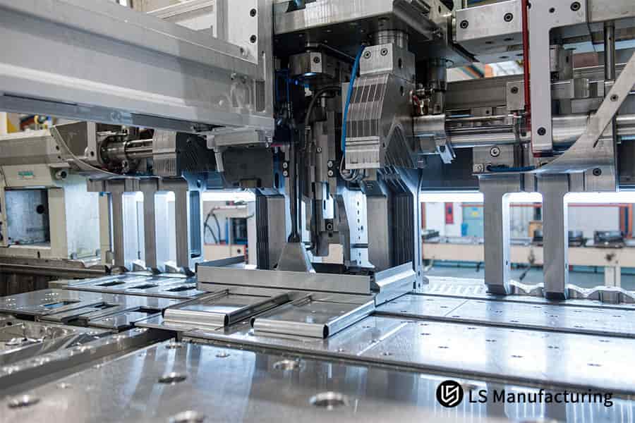 Custom sheet metal stamping feeds AL 6061 strip to 0.1 mm thickness.