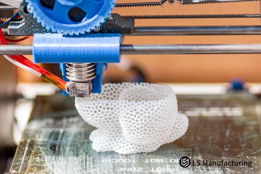 FDM 3D printing fabricates complex white nylon bracket with intricate honeycomb internal structure.
