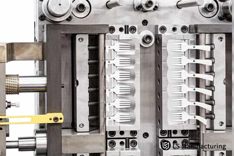 Custom injection mold tooling services machine aluminum cavities marked 10 and 11 for production.