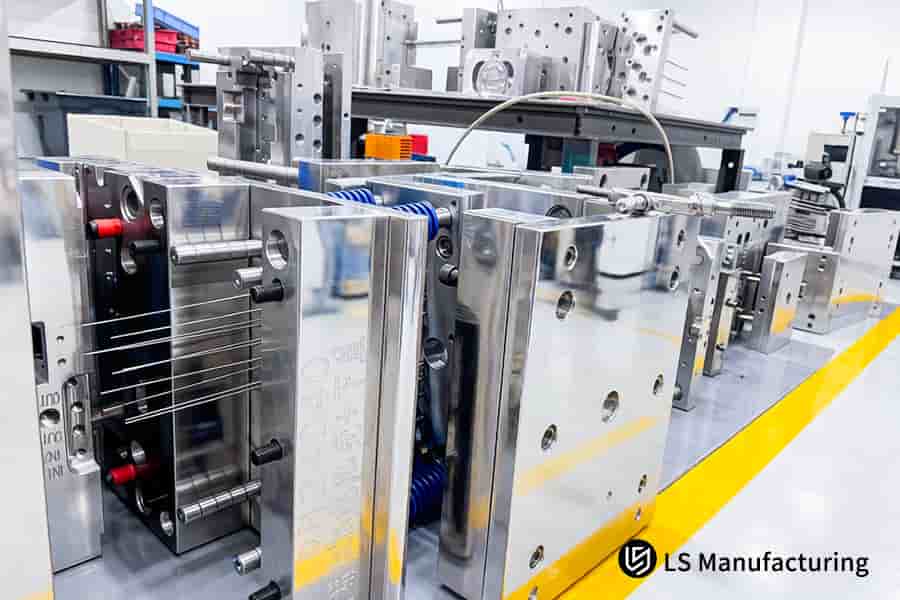 Rows of precision steel mold bases demonstrate injection molding cost control through standardized, reusable tooling.