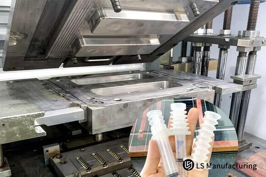 A hand holds three clear silicone medical components for visual inspection at the quality control station.