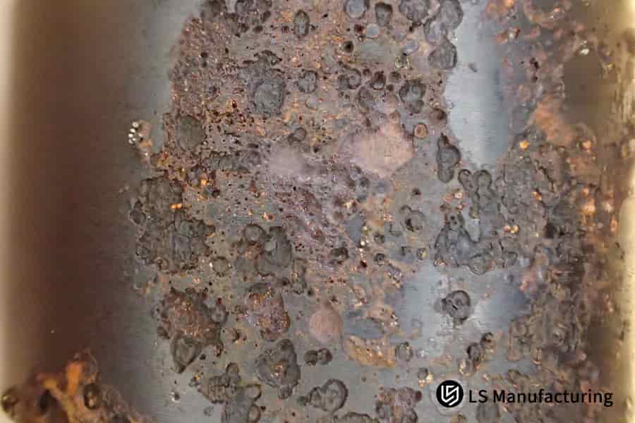 A stainless steel part with surface corrosion.