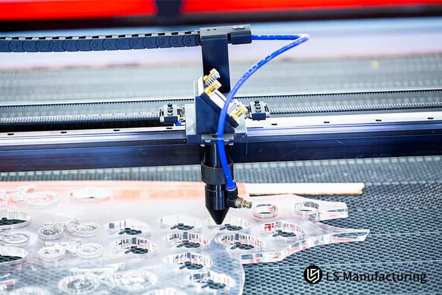 Laser cutting slices clean gasket edges on mirror acrylic for electronic device enclosures.
