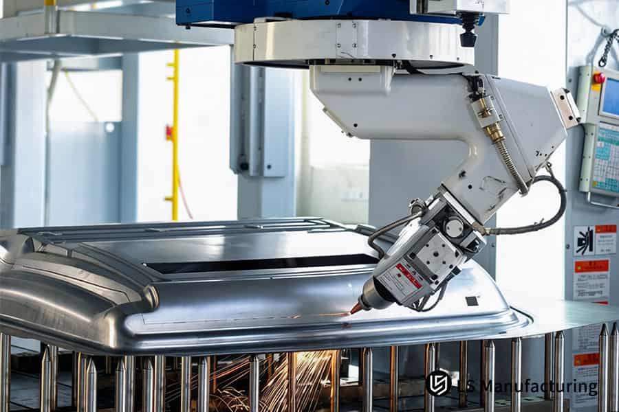 Un service de découpe laser robotisé finit un panneau de capot en acier pour l'assemblage de carrosserie automobile.
