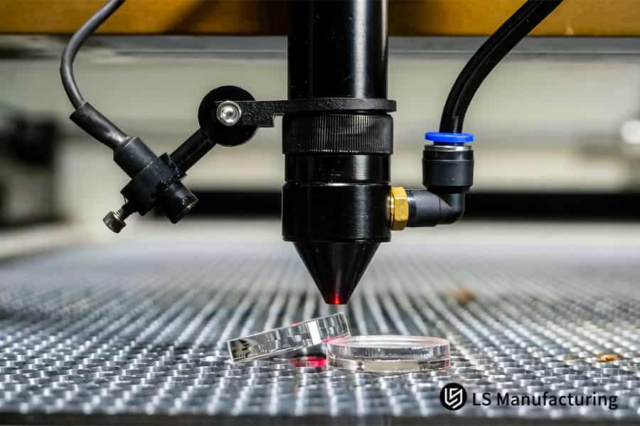 Laser cutting trims transparent polycarbonate discs for scientific laboratory research.