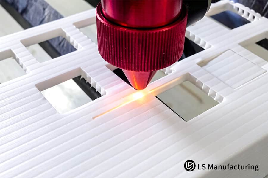 Plastic laser cutting service carves intricate slots in white PVC for electronic component storage trays.