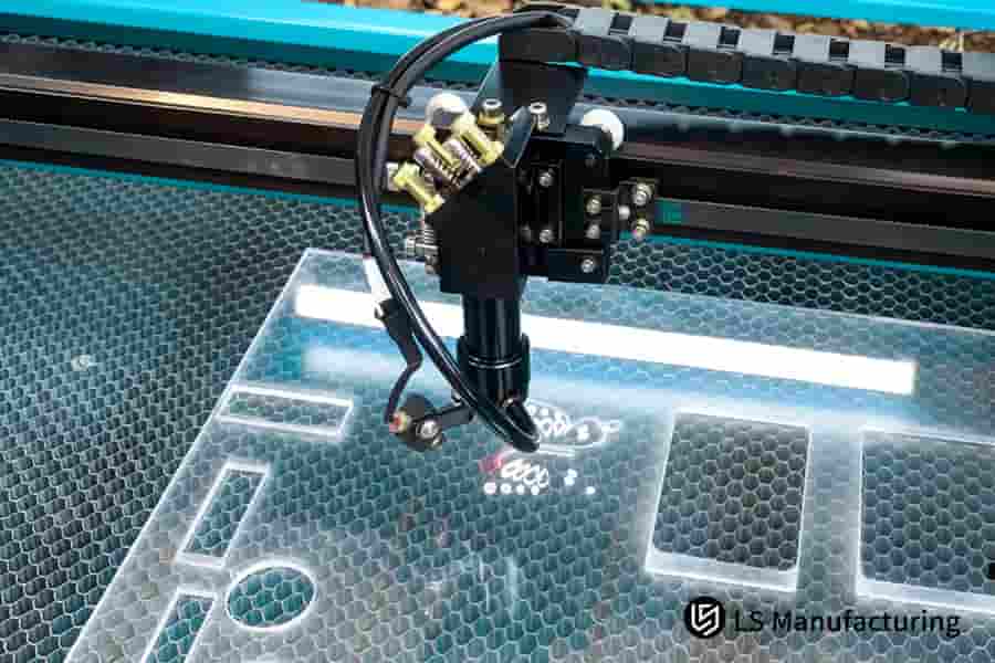 Laser cutting creates precise interlocking slots in clear acrylic for electronic device jigs.