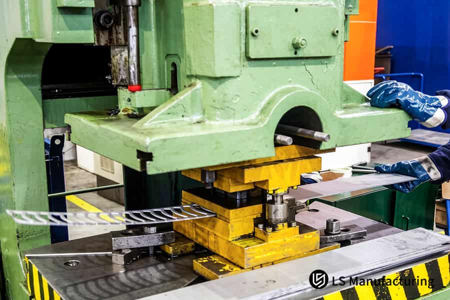 Piercing punch creates clean holes in copper strip for electrical terminals.