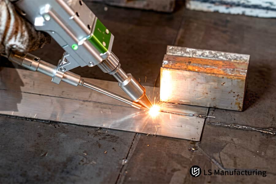 A robotic arm performs laser welding for OEMs on a steel part with flying sparks in a factory.