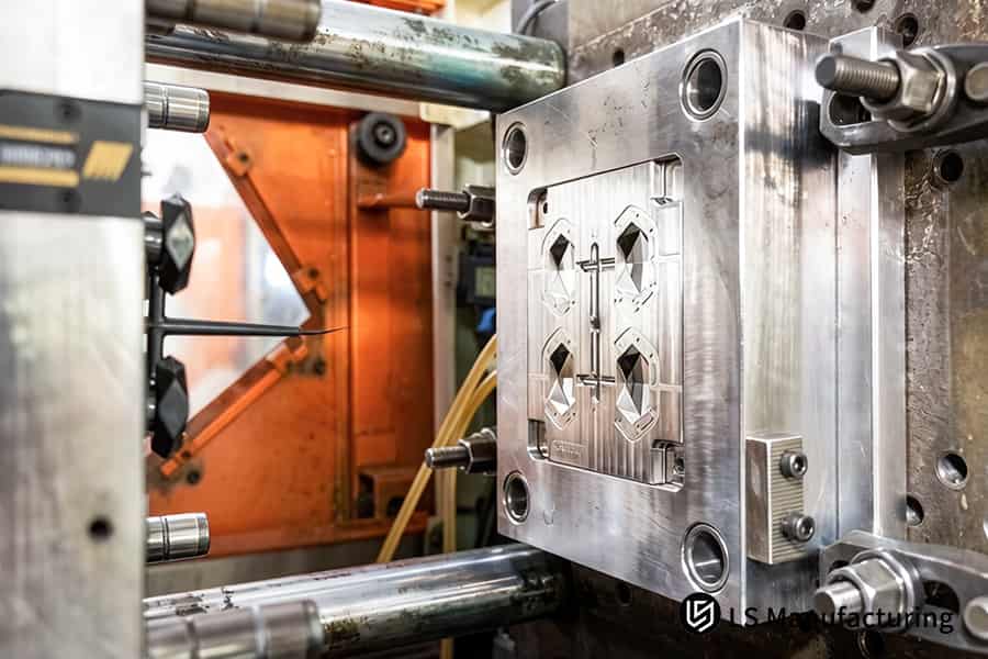 A high-strength steel mold is secured in a robust clamping fixture for upcoming overmolding production.