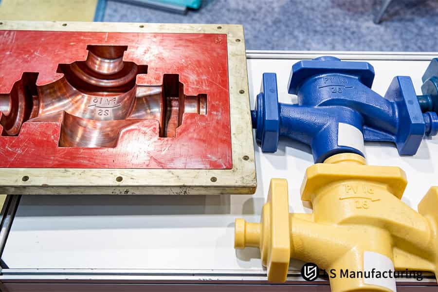 Large part injection molding forms a blue ABS component on a press marked with PV 16 and 26.