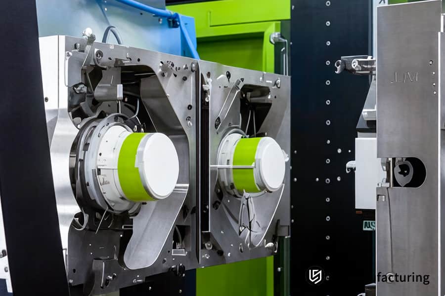 La macchina per lo stampaggio a iniezione di materie plastiche inietta la plastica PEEK fusa in stampi per parti aerospaziali di precisione.