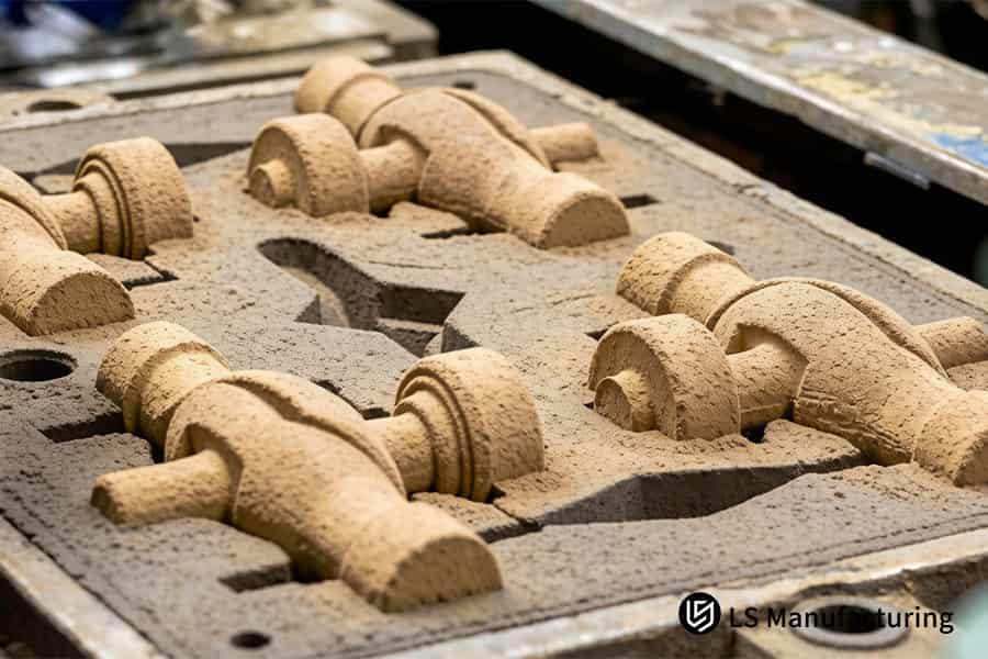 Extracting precision sand cores reveals complex internal water cooling channels for automotive manifolds.