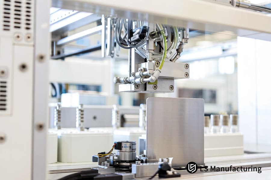 A technician processes 316L stainless steel sheets for a custom medical sheet metal components​ manufacturing line.