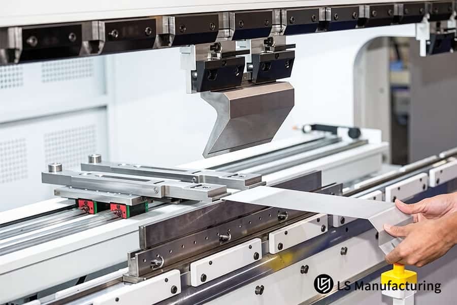 A CNC press brake bends a long 6061 aluminum bracket, a process factored into precision sheet metal cost​ calculations.