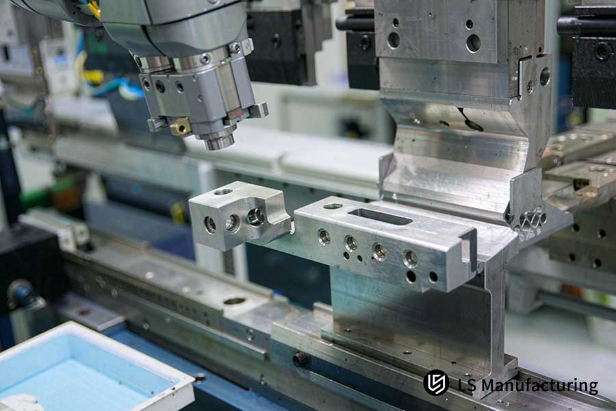 Semiconductor sheet metal fabrication service bends 6061-T6 aluminum on press.