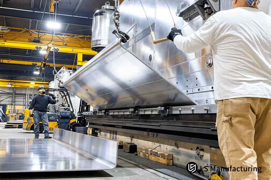 An operator measures a bend on 304 stainless steel for heavy machinery, allowing you to get fabrication quote online.
